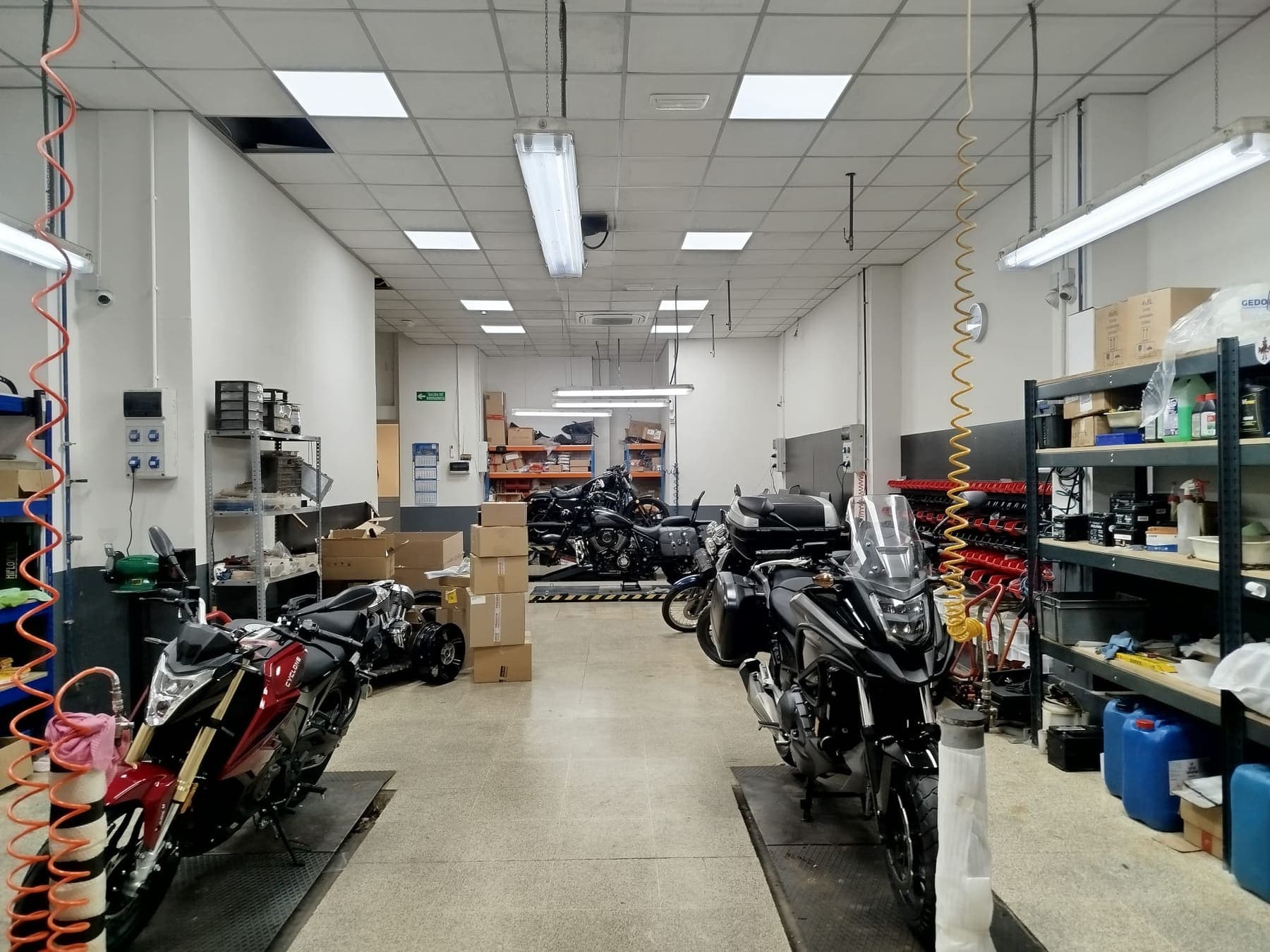 Interior del taller de motos de MotoCasionWEB en Sedaví (Valencia) con motos en los elevadores